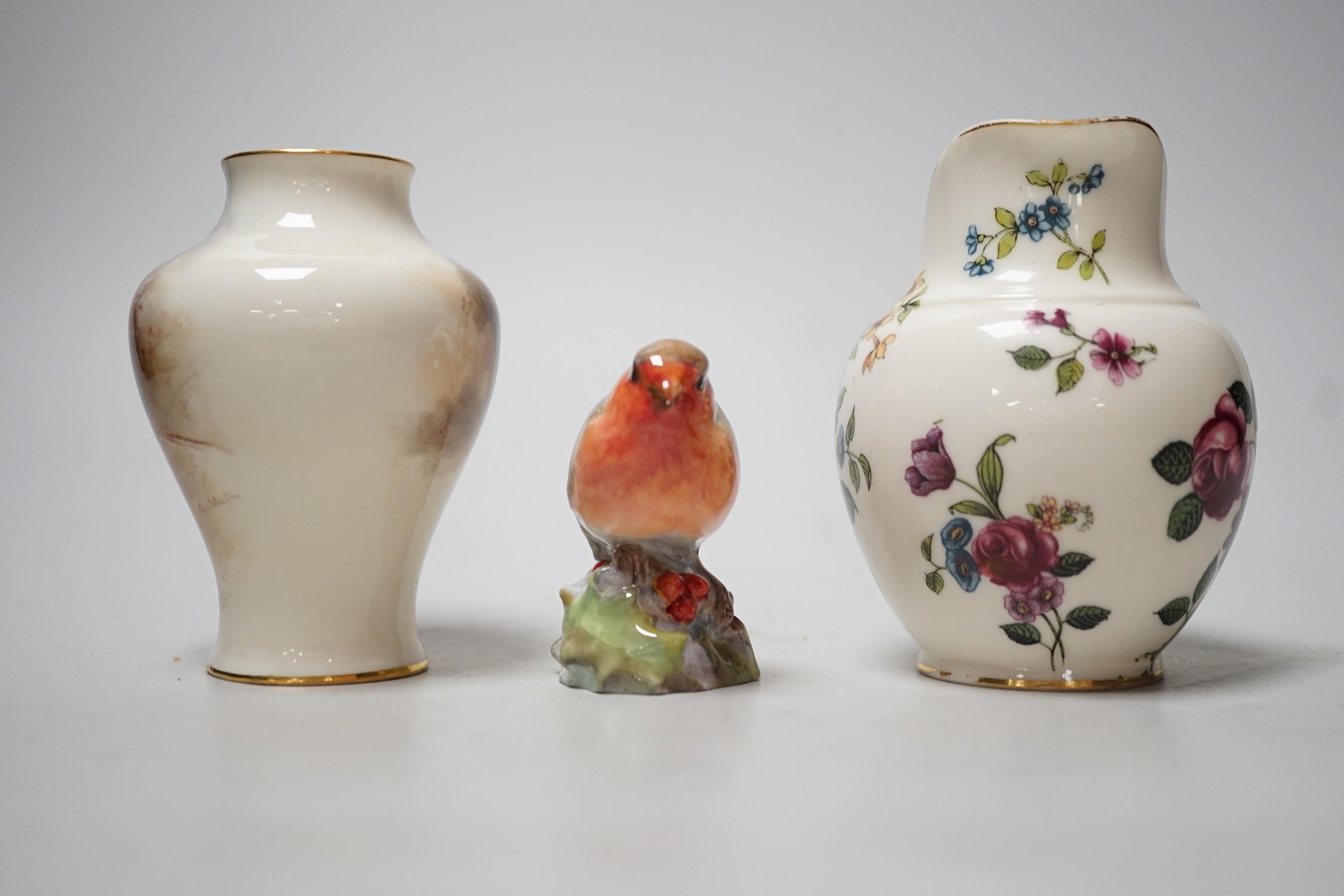 A Royal Worcester James Stinton vase with pheasant decoration, together with a Royal Worcester jug and a Royal Worcester robin figure. Tallest 10cm